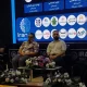 Four panel participants seated onstage before an Iran AI backdrop.