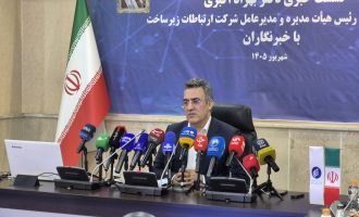 Behzad Akbari seated behind microphones at a press conference. Iran internet filtering