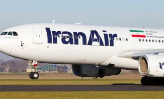 Front section of a white aircraft with Iran Air lettering and an Iranian flag.