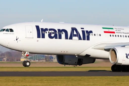 Front section of a white aircraft with Iran Air lettering and an Iranian flag.