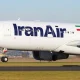 Front section of a white aircraft with Iran Air lettering and an Iranian flag.