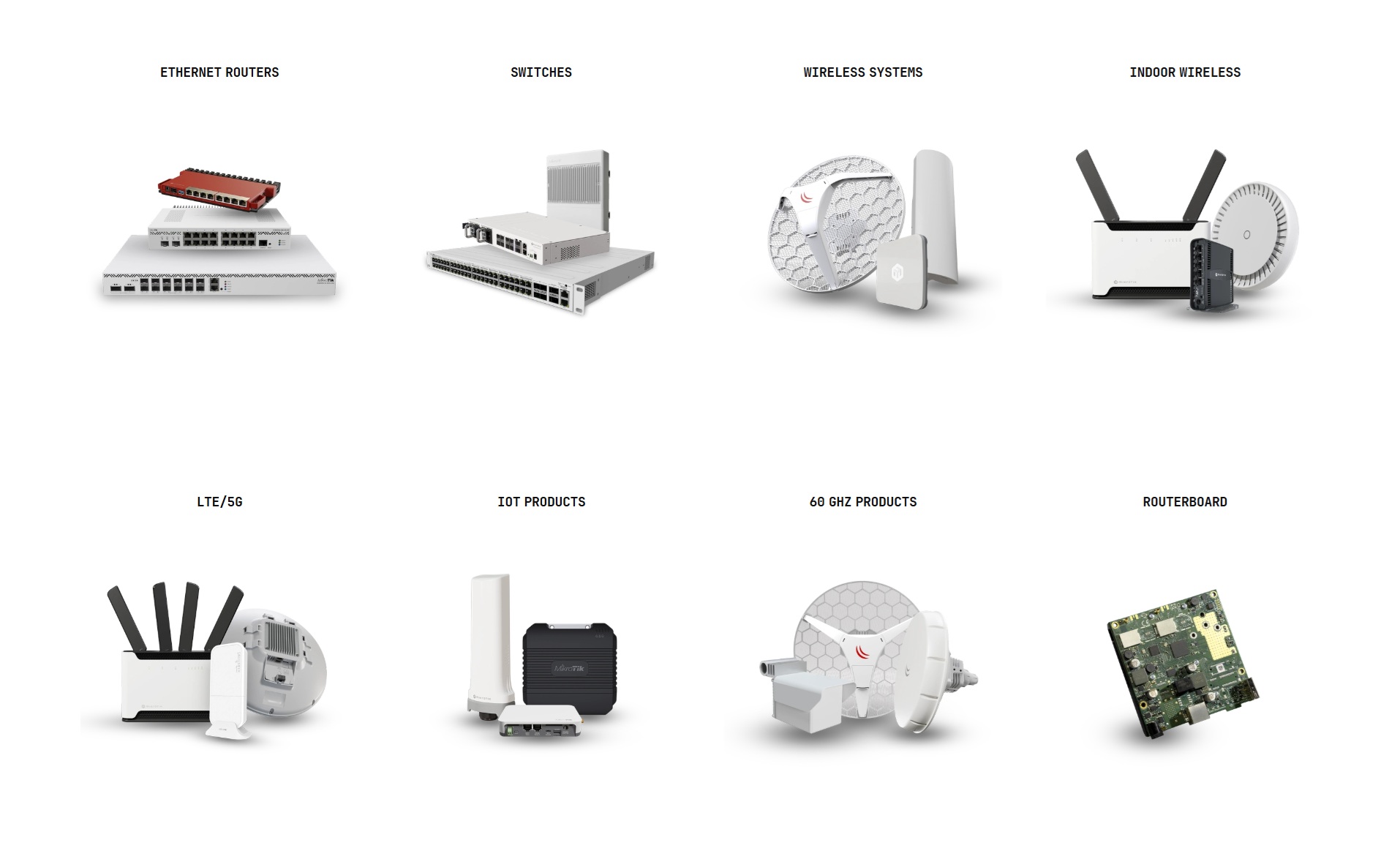 Several white MikroTik routers and networking devices arranged on a dark surface.
