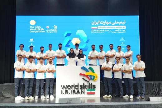 Members of Iran’s national skills team pose behind a WorldSkills Iran sign.