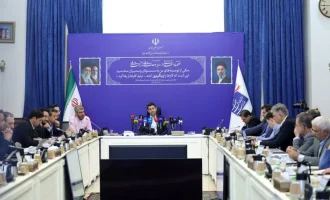 Officials and telecom operators seated around a table at a fiber-optic project meeting