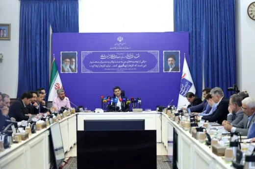Officials and telecom operators seated around a table at a fiber-optic project meeting