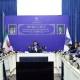 Officials and telecom operators seated around a table at a fiber-optic project meeting