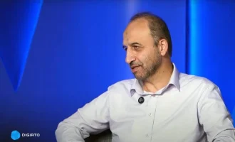 Mohammad Sarafraz seated against a blue studio backdrop.