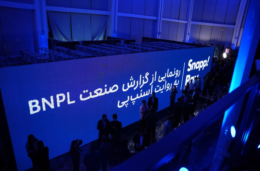 Attendees beside a blue SnappPay BNPL event backdrop.