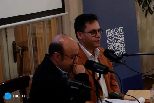 Two speakers seated at microphones beside a RabtHost banner.