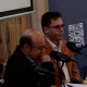 Two speakers seated at microphones beside a RabtHost banner.